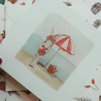 Hasenmädchen am Strand / Klappkarte - The Baltic Shop